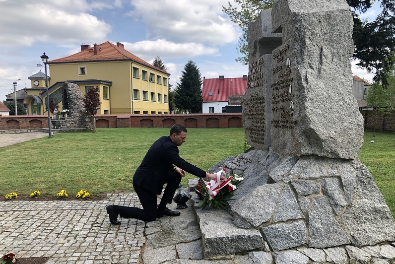Członek Zarządu Powiatu Krotoszyńskiego Miłosz Zwierzyk składa wiązankę kwiatów pod pomnikiem.